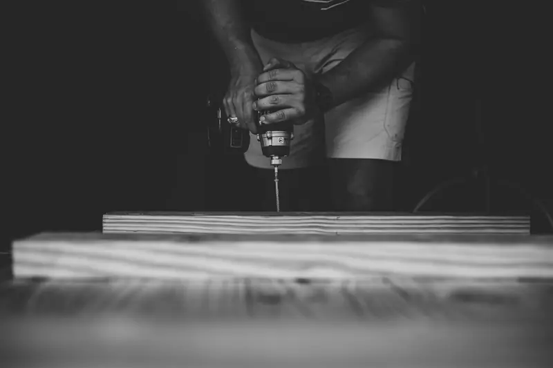 Prime Services Solutions crew member drilling into a wood surface during a unit repair